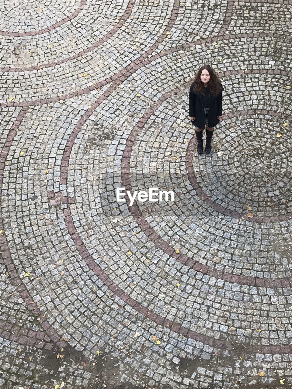 High angle view of woman standing on footpath