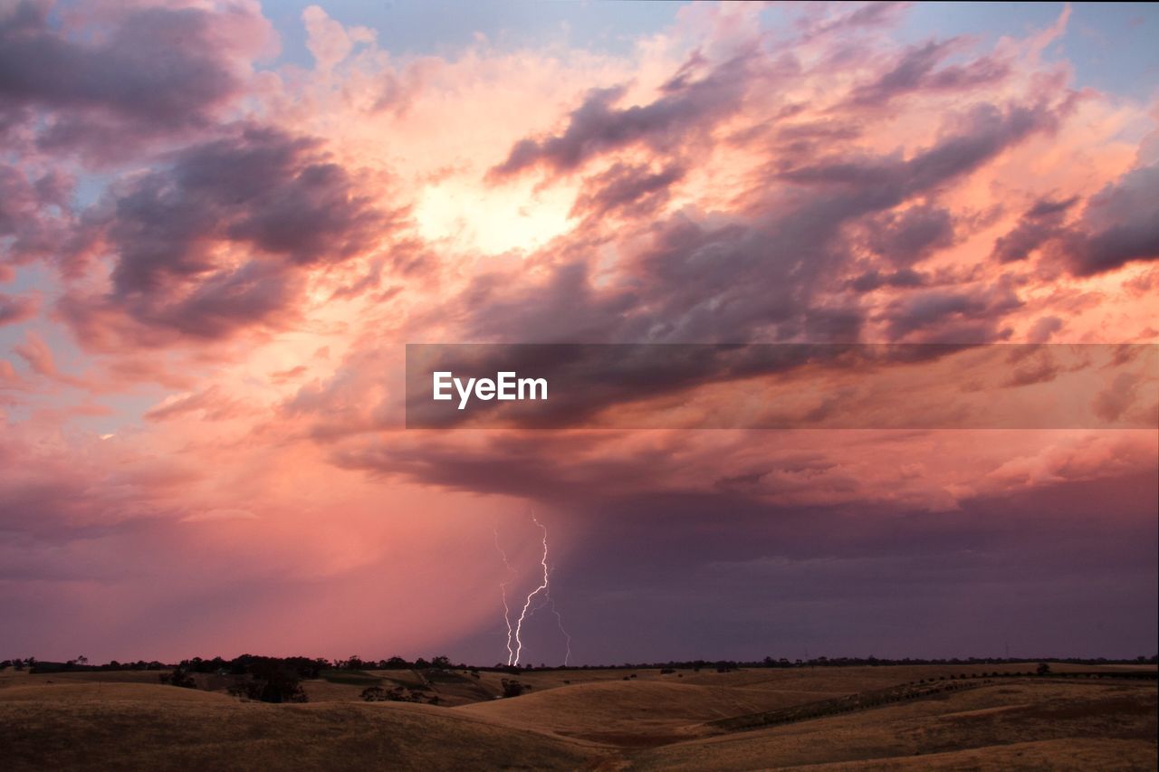 Scenic view of lightning striking field