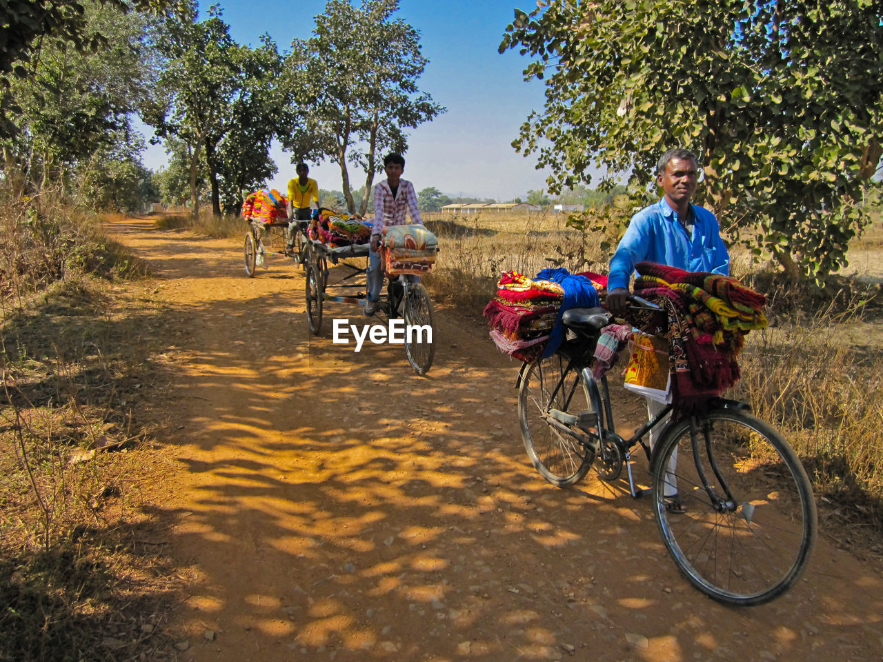 PEOPLE RIDING BICYCLES ON ROAD