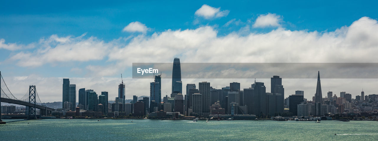 PANORAMIC VIEW OF MODERN BUILDINGS AGAINST SKY