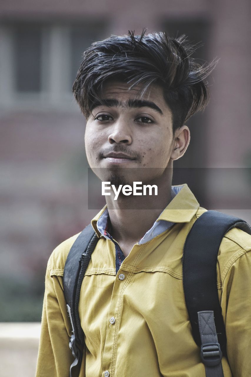 Portrait of young man standing outdoors