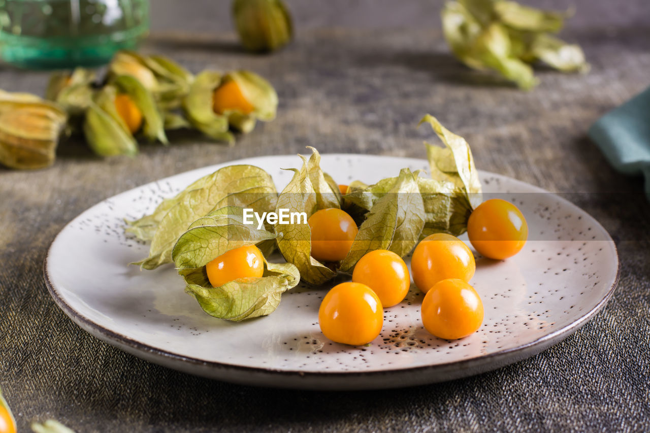 Ripe fruit physalis on a plate. organic vegetarian food.