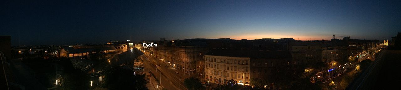 Aerial view of illuminated city at dusk