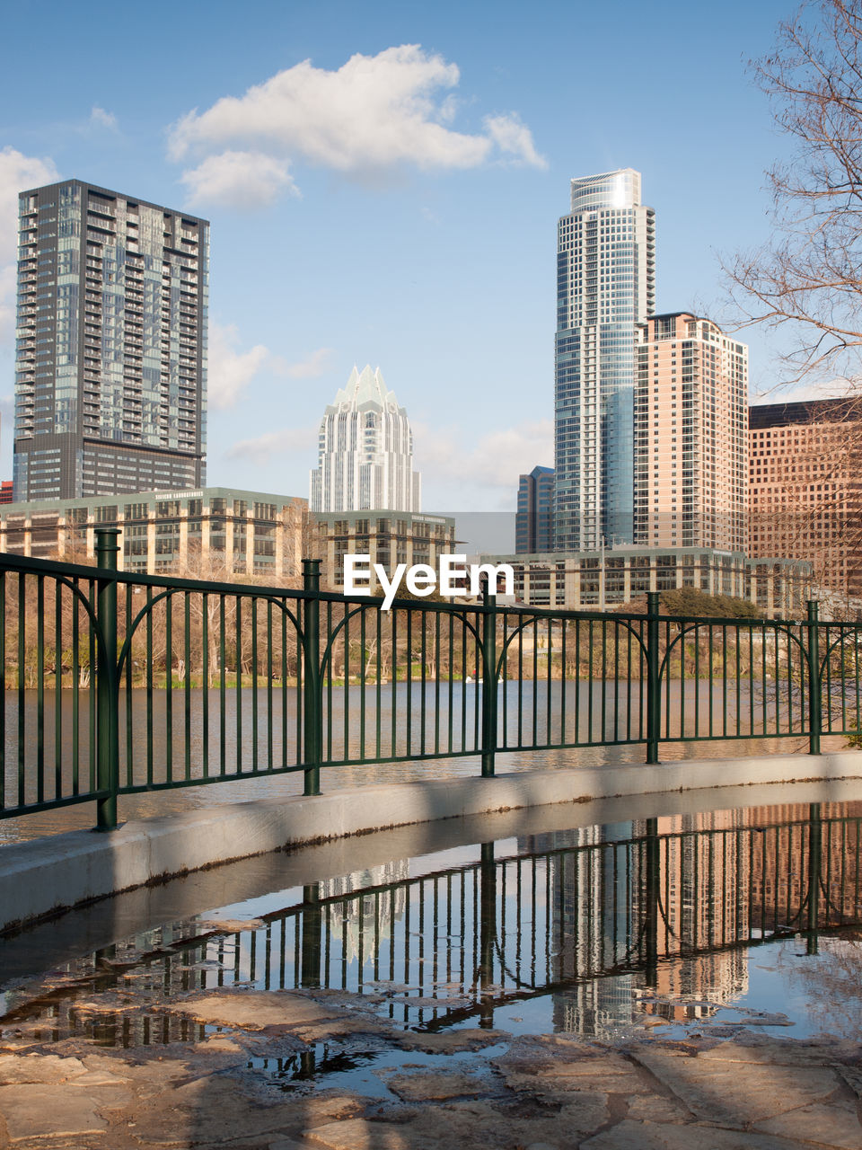 Bridge over river in city against sky