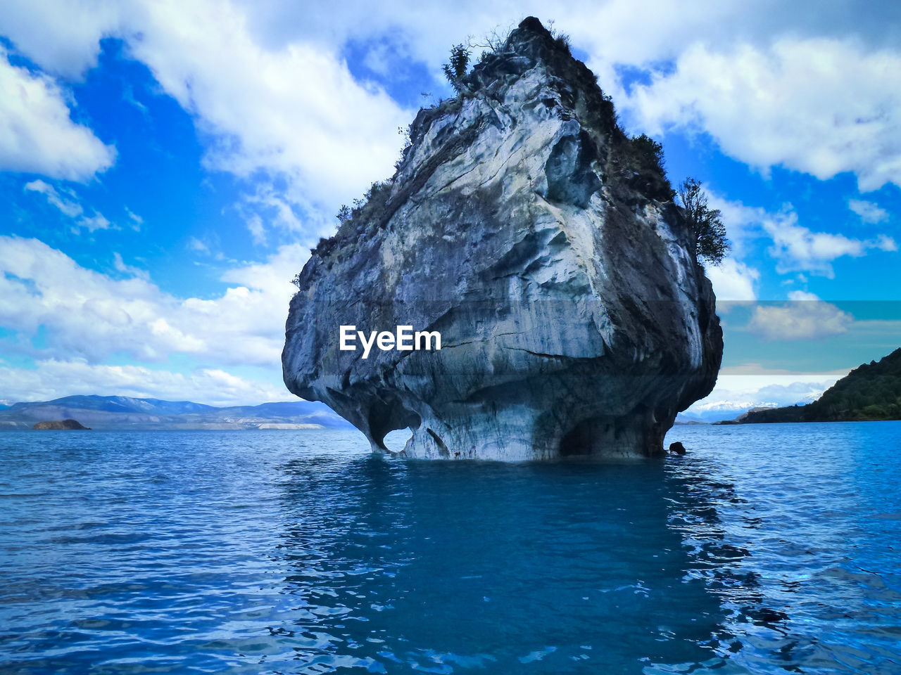 Rock formation in sea against sky