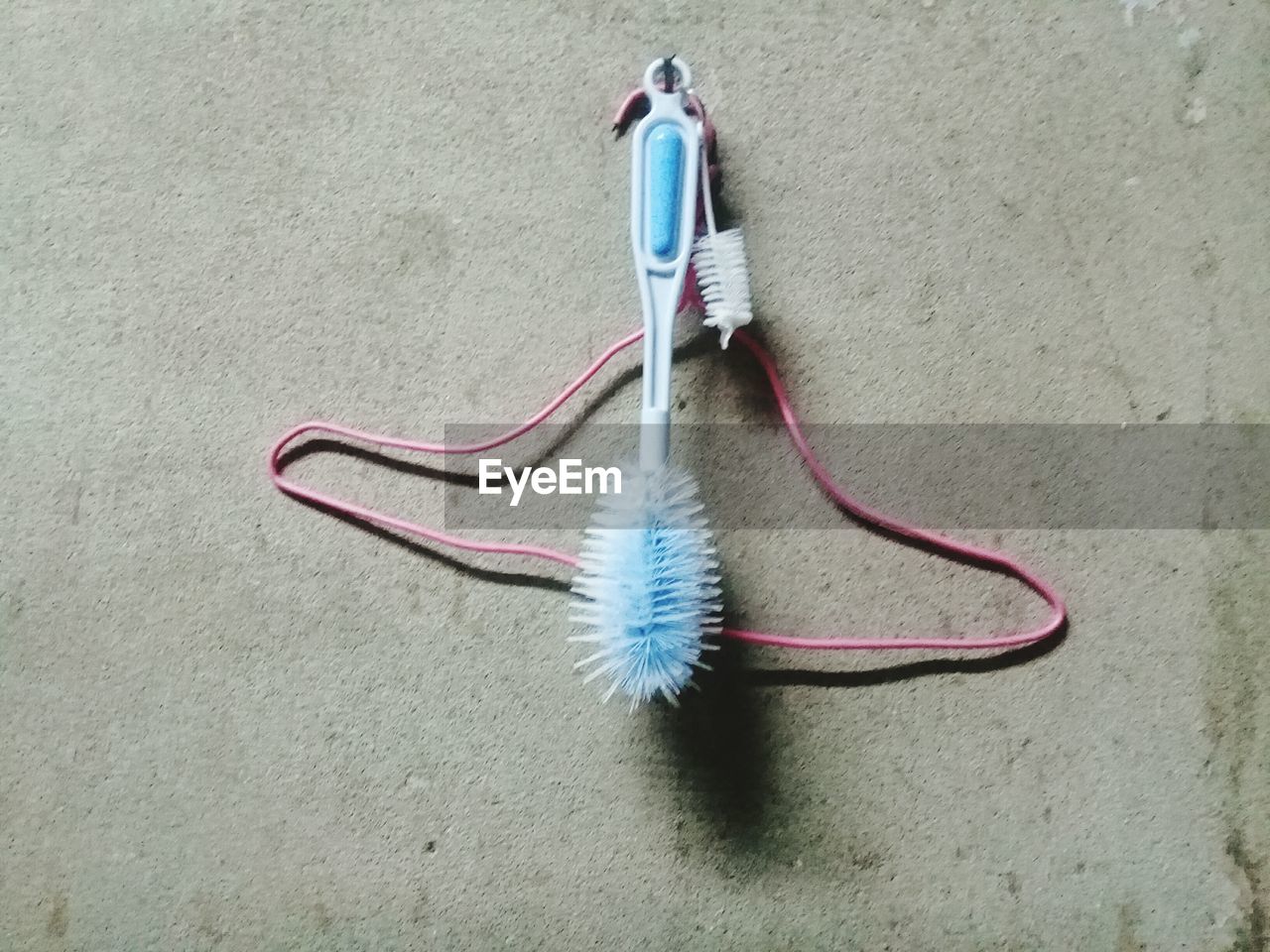 HIGH ANGLE VIEW OF CLOTHES HANGING AGAINST WALL