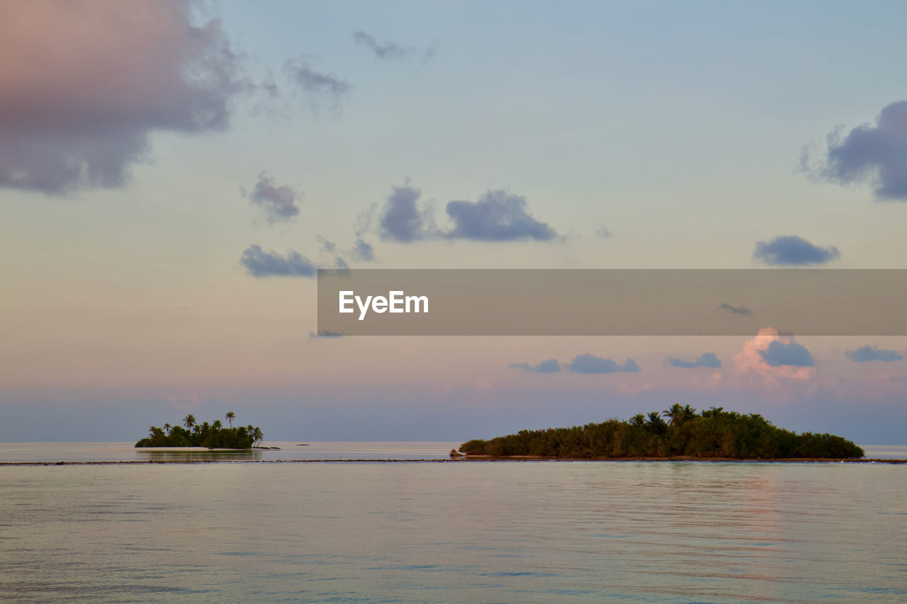 water, sky, sea, cloud, shore, horizon, beauty in nature, scenics - nature, nature, ocean, land, sunset, tree, tranquility, dusk, environment, coast, body of water, travel, travel destinations, beach, bay, tropical climate, tranquil scene, plant, no people, island, outdoors, nautical vessel, landscape, seascape, palm tree, tourism, idyllic, reflection, holiday, horizon over water, vacation, trip, evening, vehicle, coastline, transportation, architecture, wave, day, non-urban scene