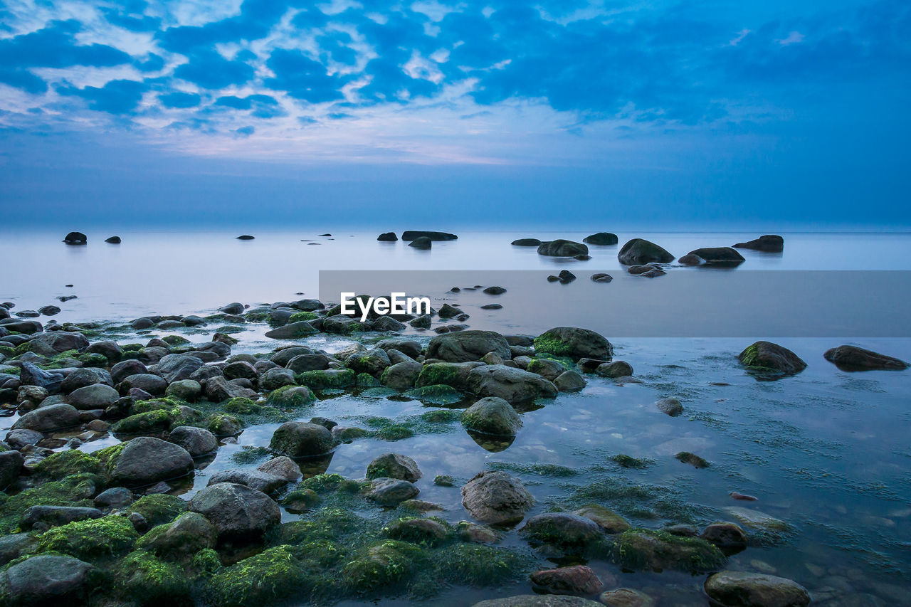 Scenic view of sea against blue sky