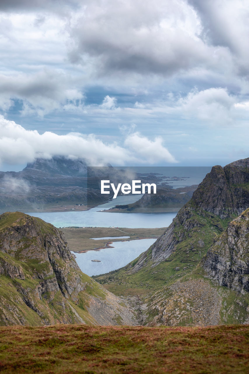 Scenic view of land and mountains against sky