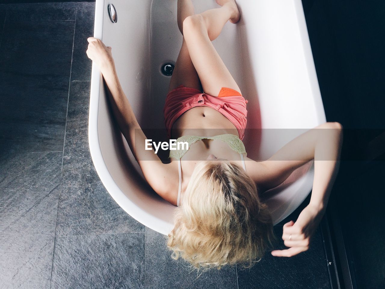 High angle view of young woman relaxing in bathtub