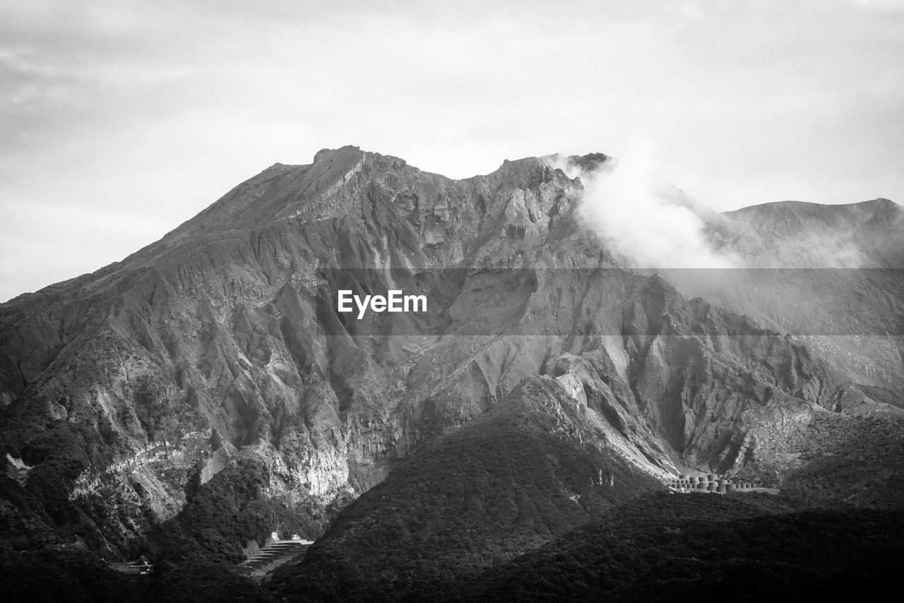 VIEW OF VOLCANIC MOUNTAIN AGAINST SKY