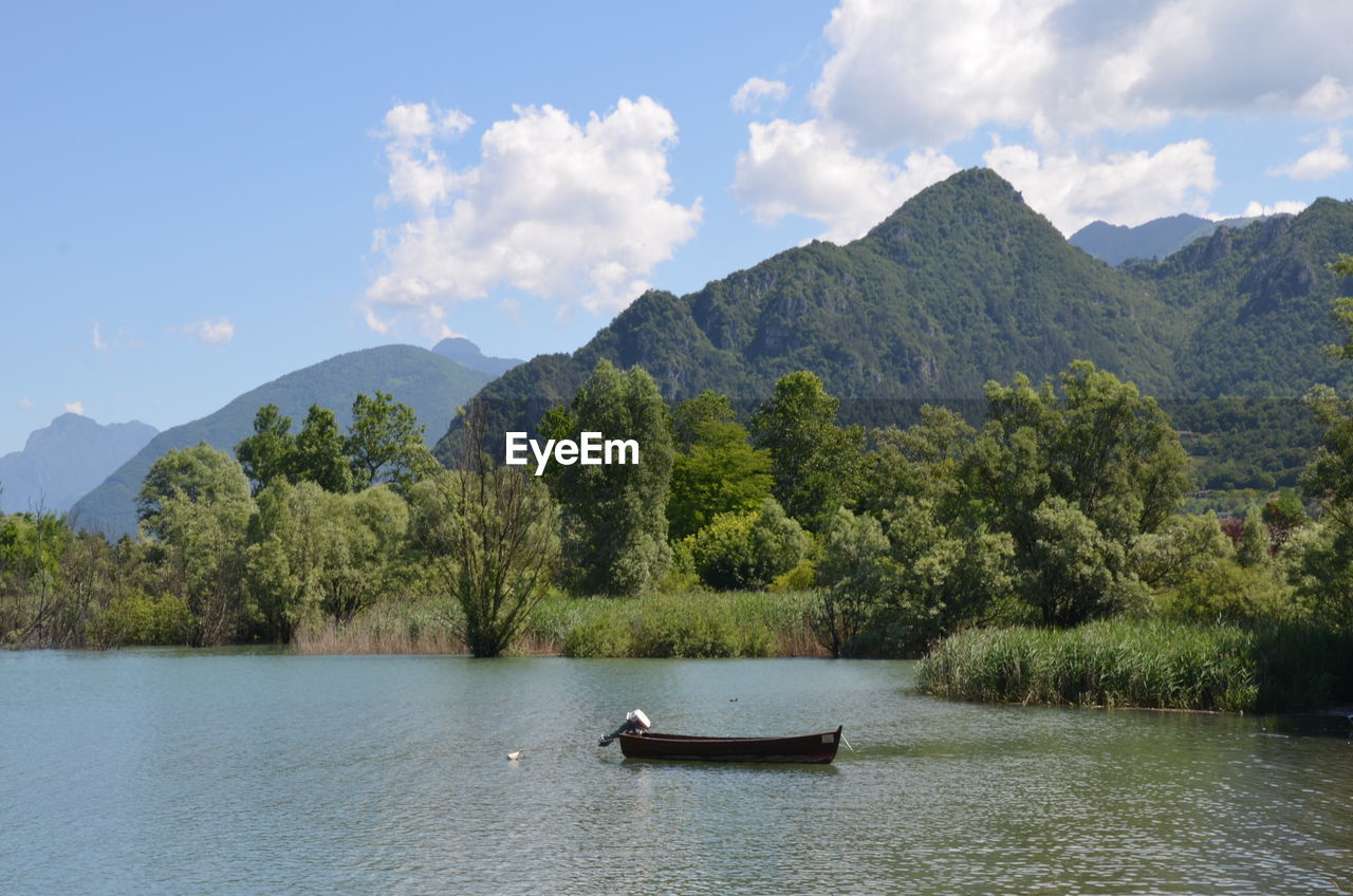 Scenic view of lago d'idro and mountains against sky