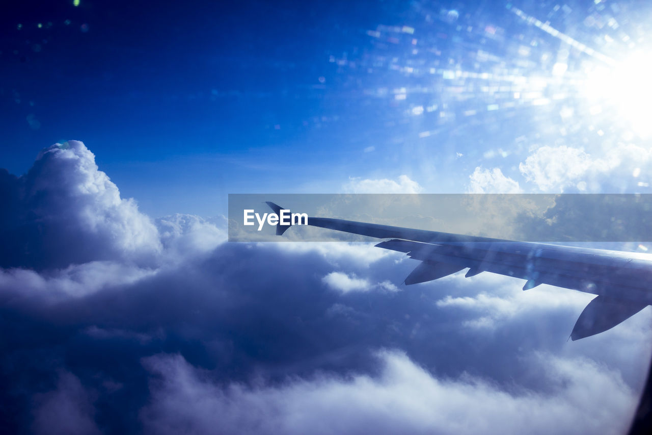 AIRPLANE FLYING OVER CLOUDS