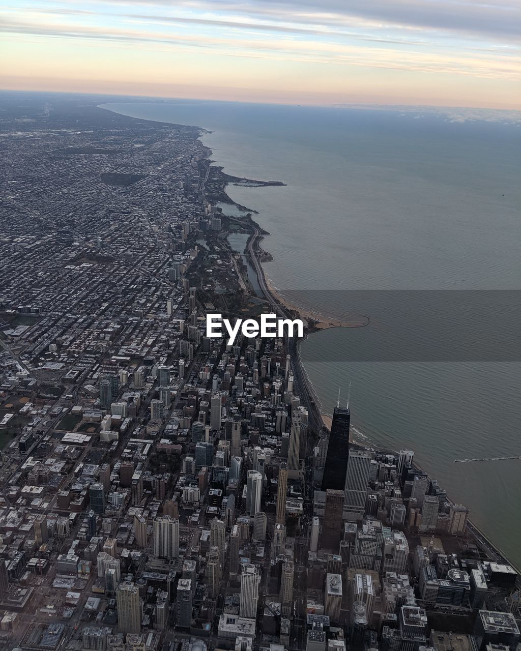 High angle view of buildings by sea against sky