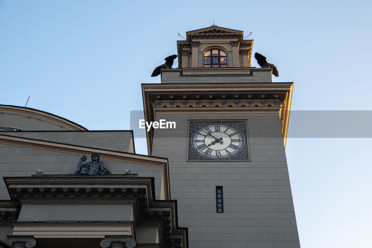 Low angle view of clock tower against clear sky