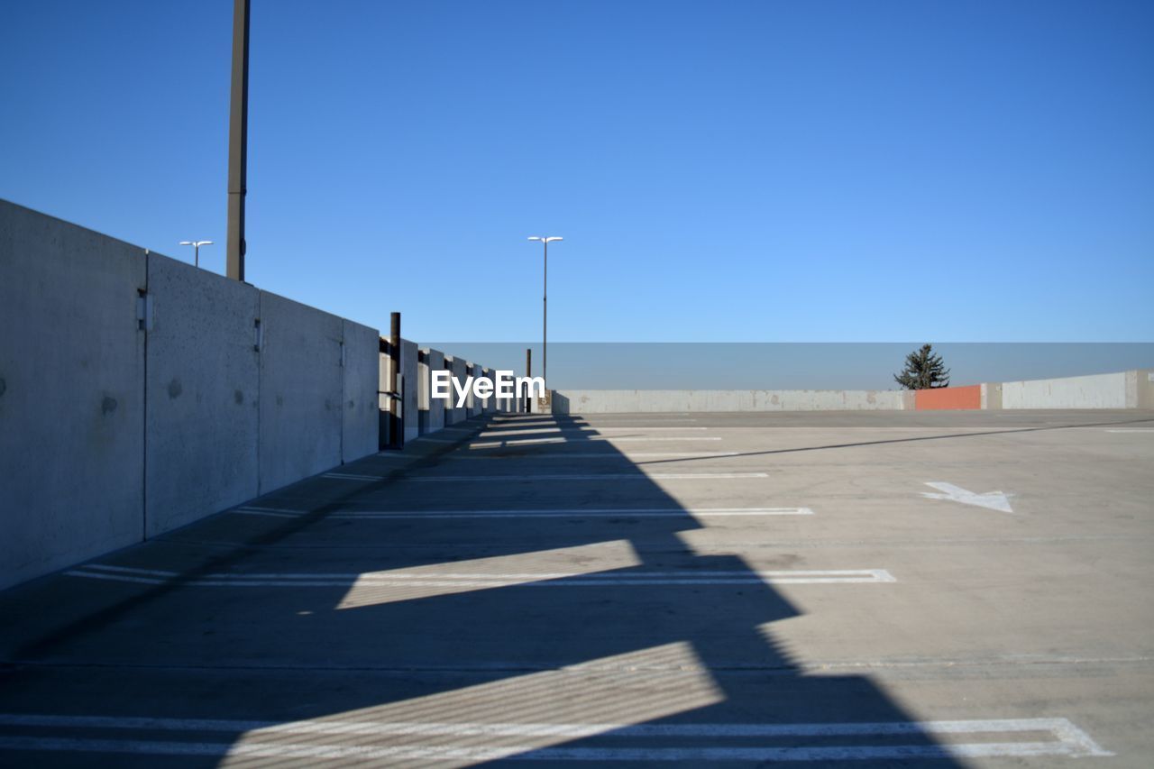 Empty parking lot against clear sky