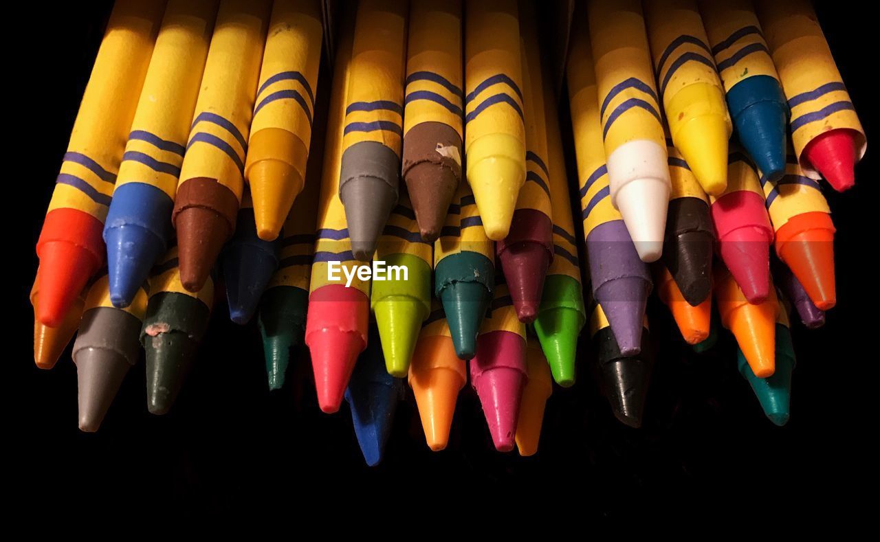 High angle view of colorful crayons on black background