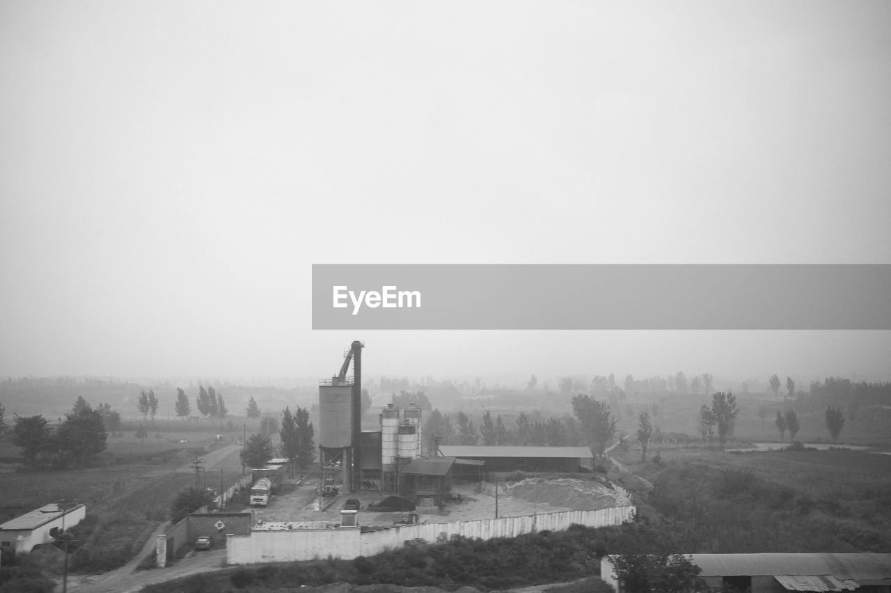 VIEW OF CITYSCAPE AGAINST CLEAR SKY DURING FOGGY WEATHER