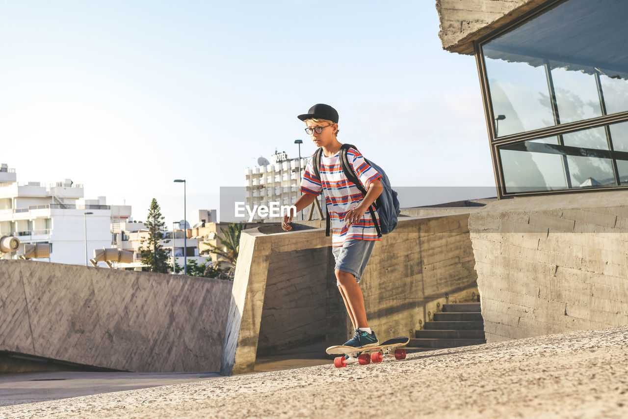 YOUNG MAN AGAINST SKY IN CITY