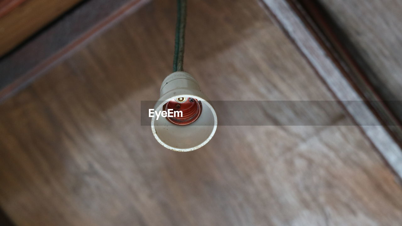 Low angle view of bulb holder hanging on ceiling