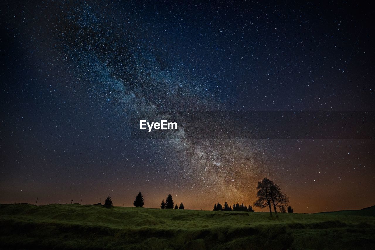 Scenic view of land against sky at night