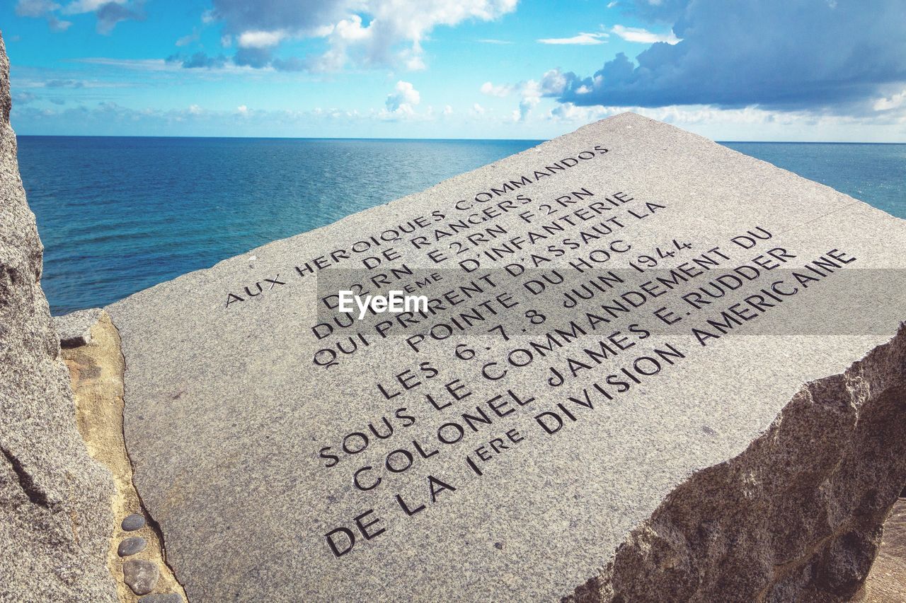 TEXT ON BEACH AGAINST SEA