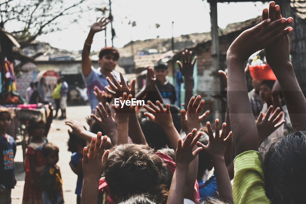 Group of children raising their hands