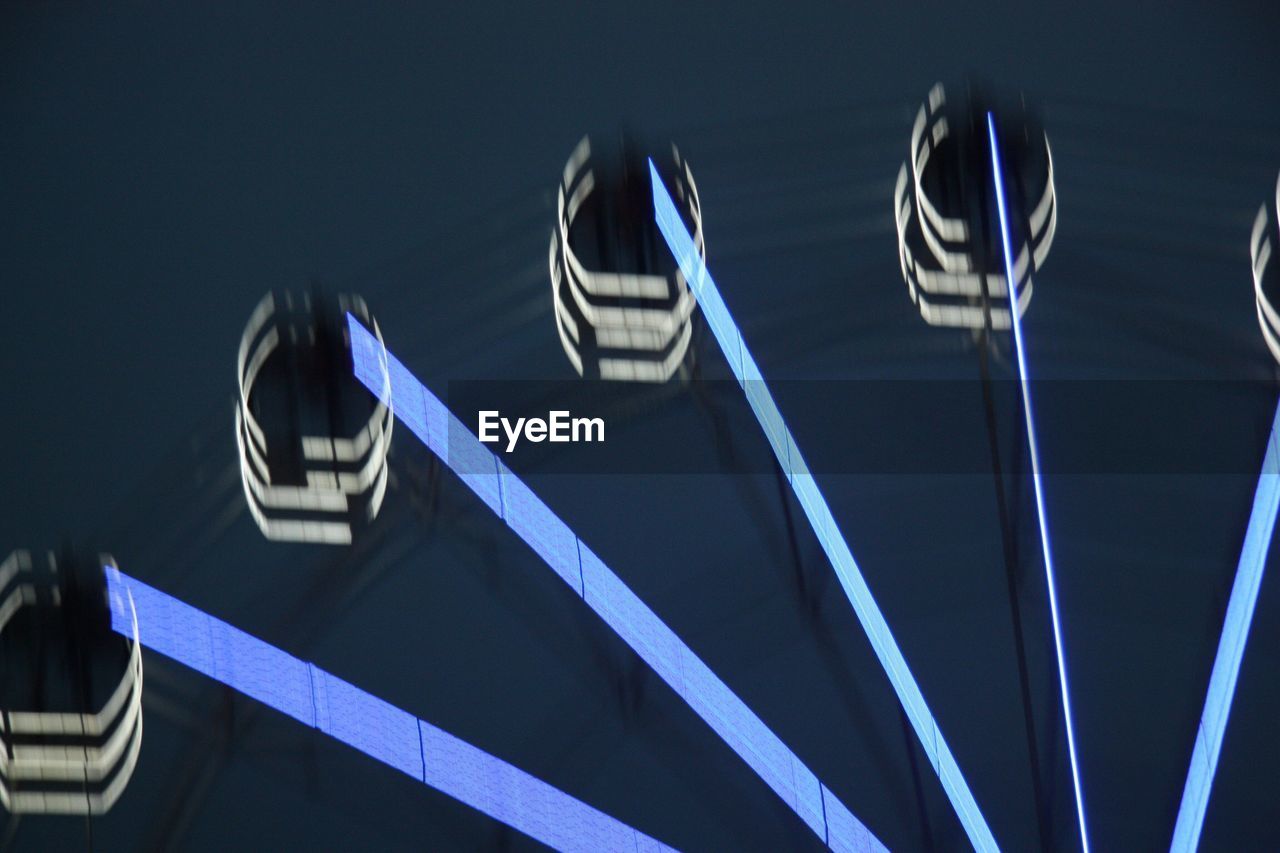 Low angle view of illuminated ferris wheel at night