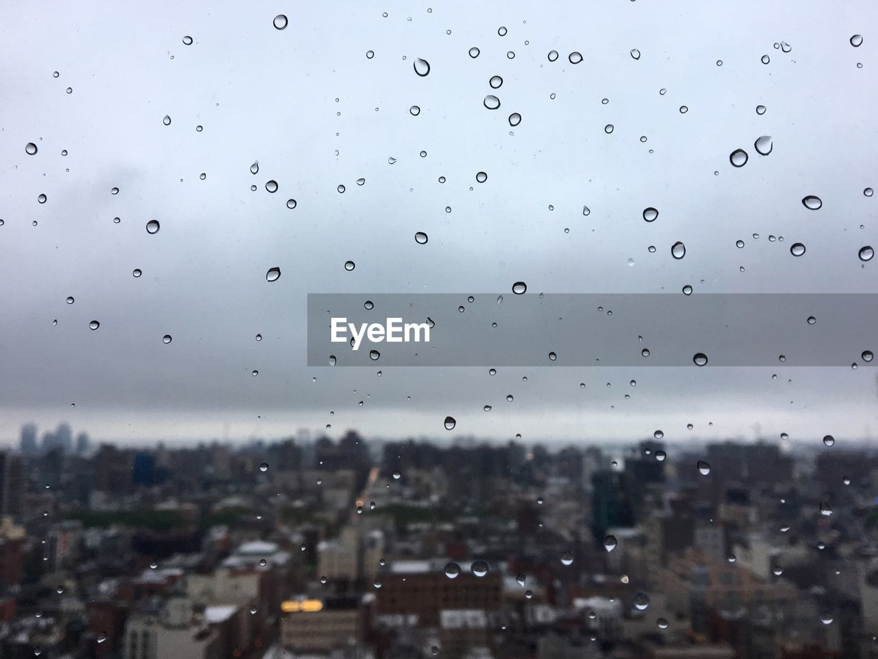 Close-up of wet window in city