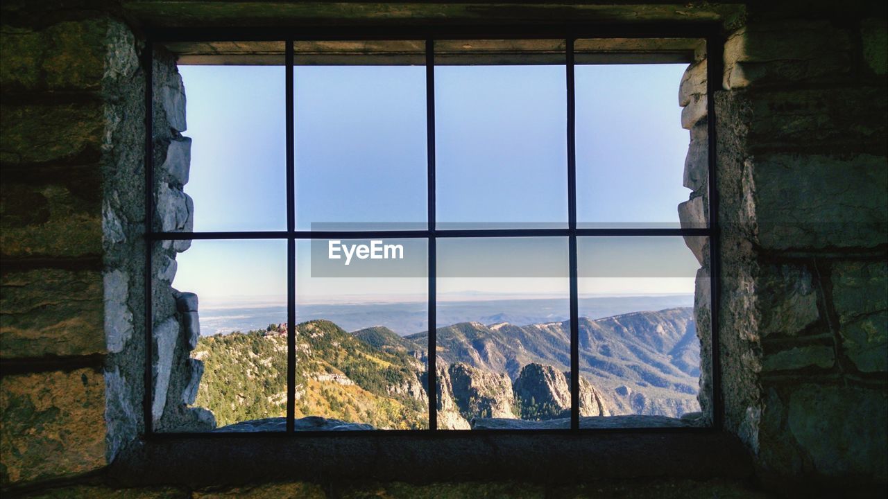 Mountain and sky seen through window