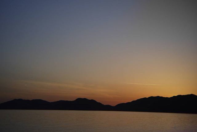 SCENIC VIEW OF SEA AT SUNSET