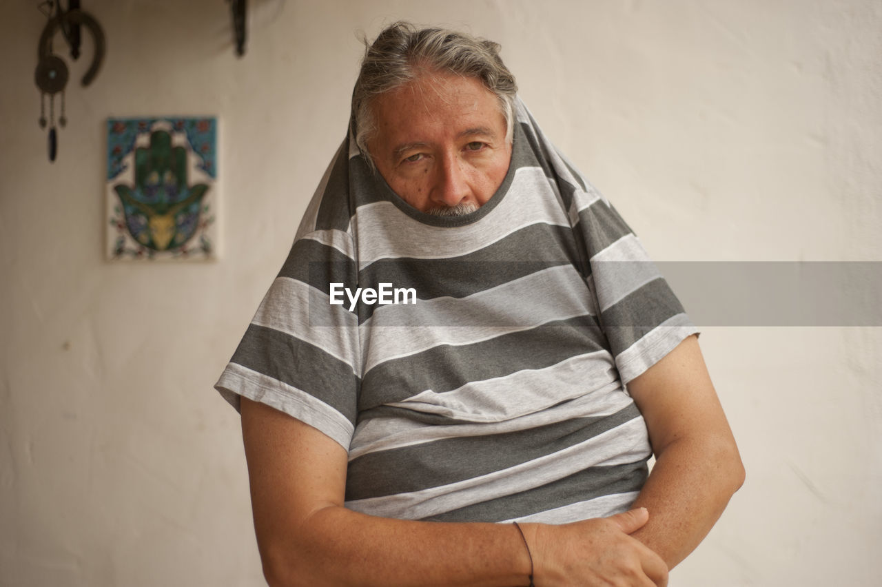 Senior man wearing t-shirt at home