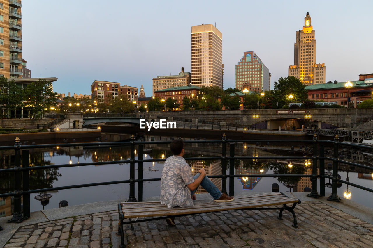 Lone man sitting on a bench in downtown providence