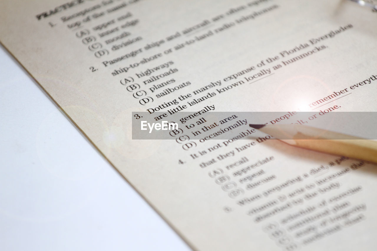 Close-up of book by pencil on table