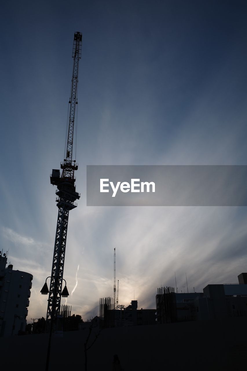 LOW ANGLE VIEW OF SILHOUETTE CRANE AGAINST SKY