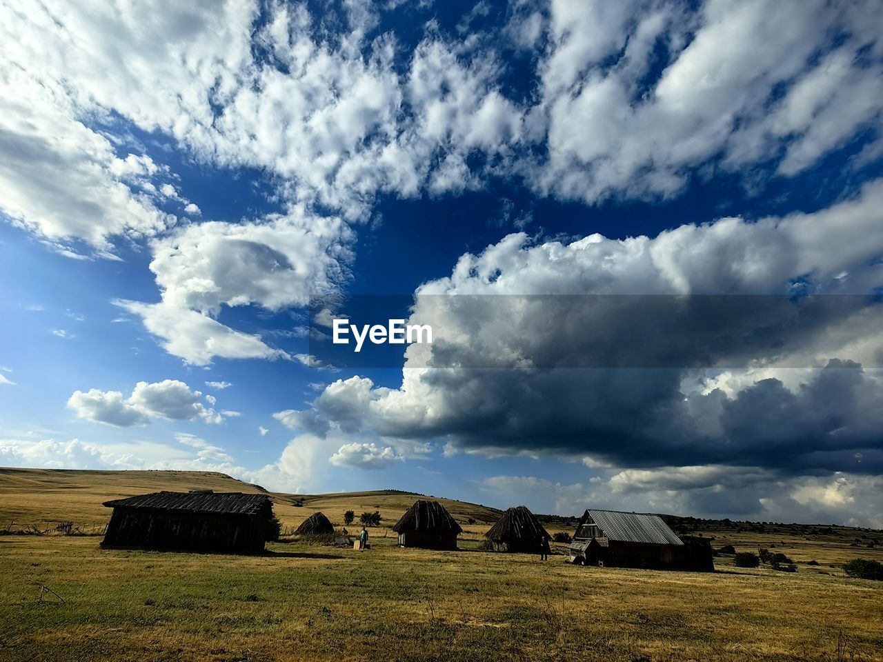 scenic view of field against cloudy sky