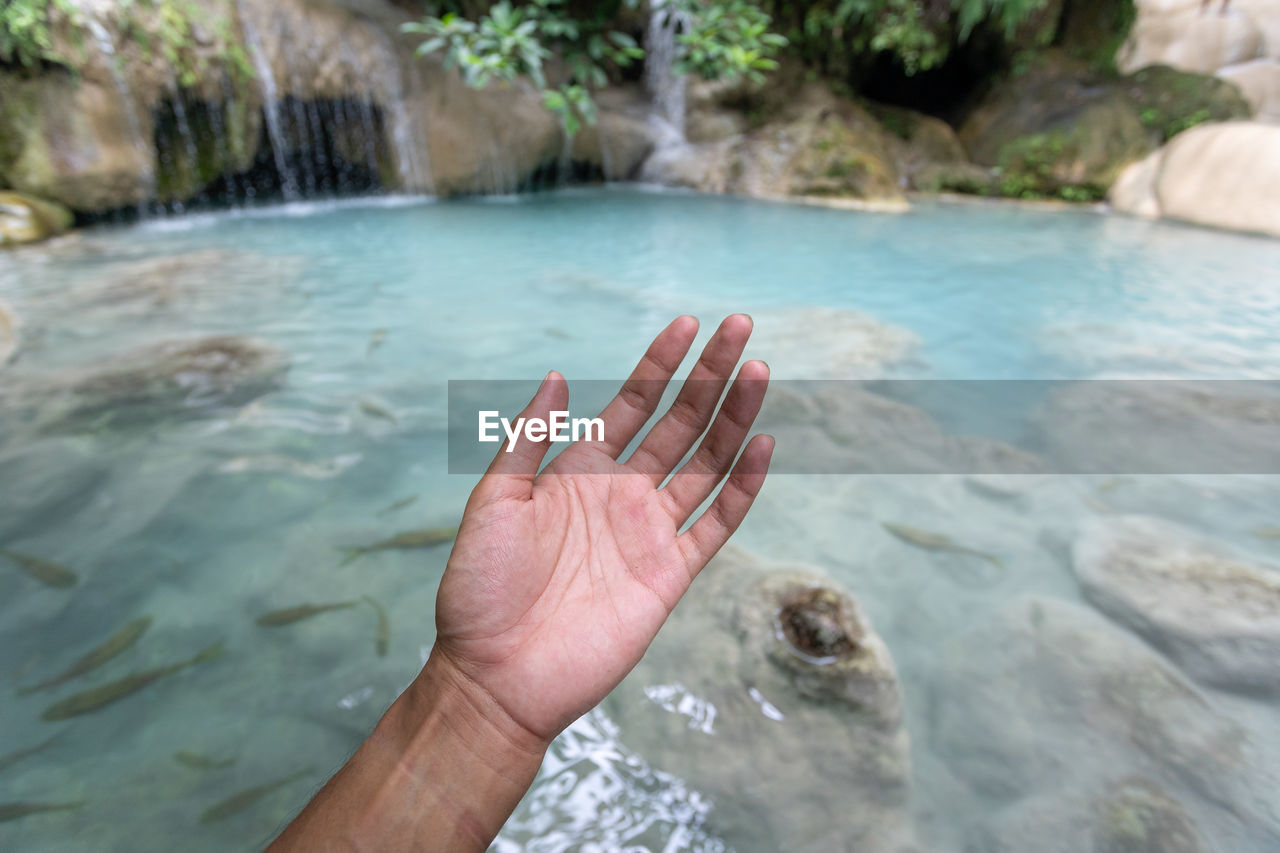 Person hand in water