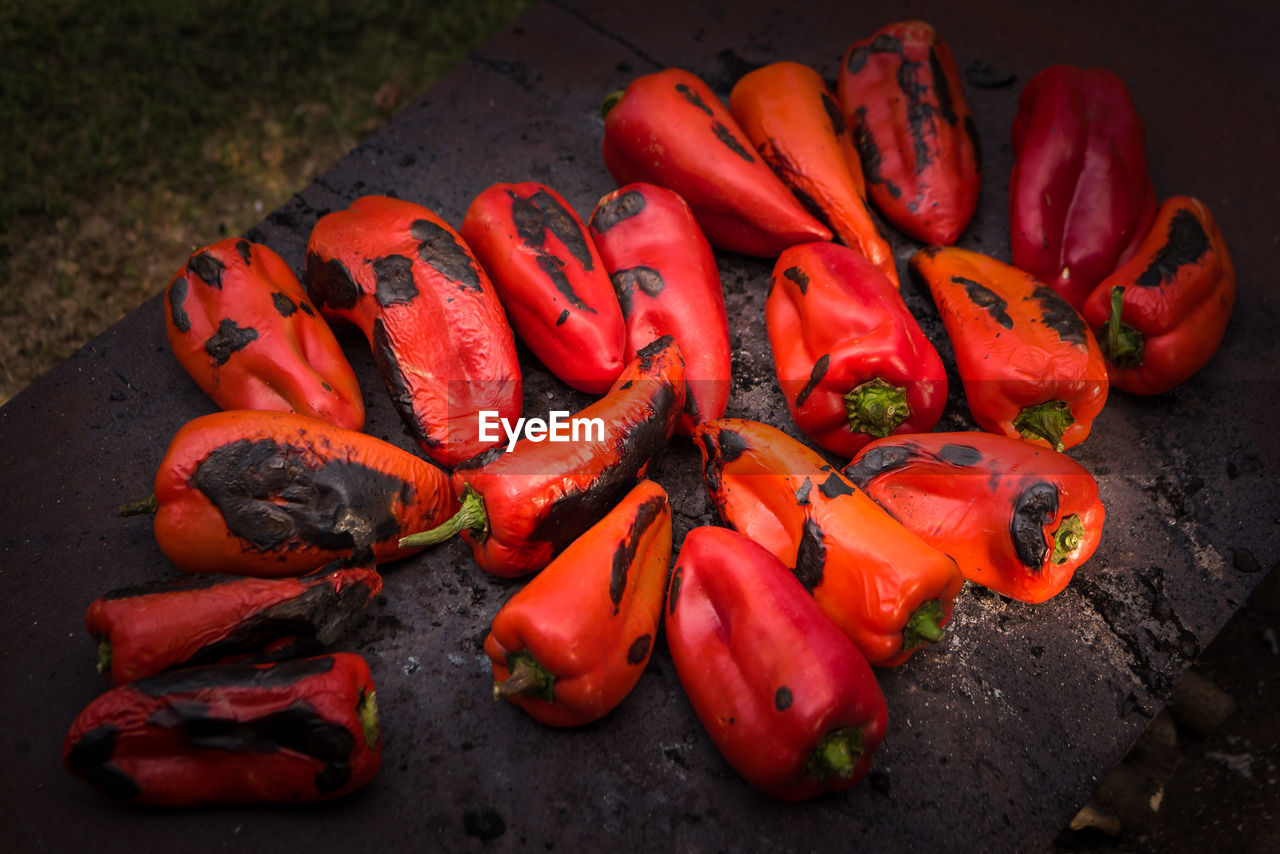Close-up view of baked chili peppers on hot iron plate outdoors