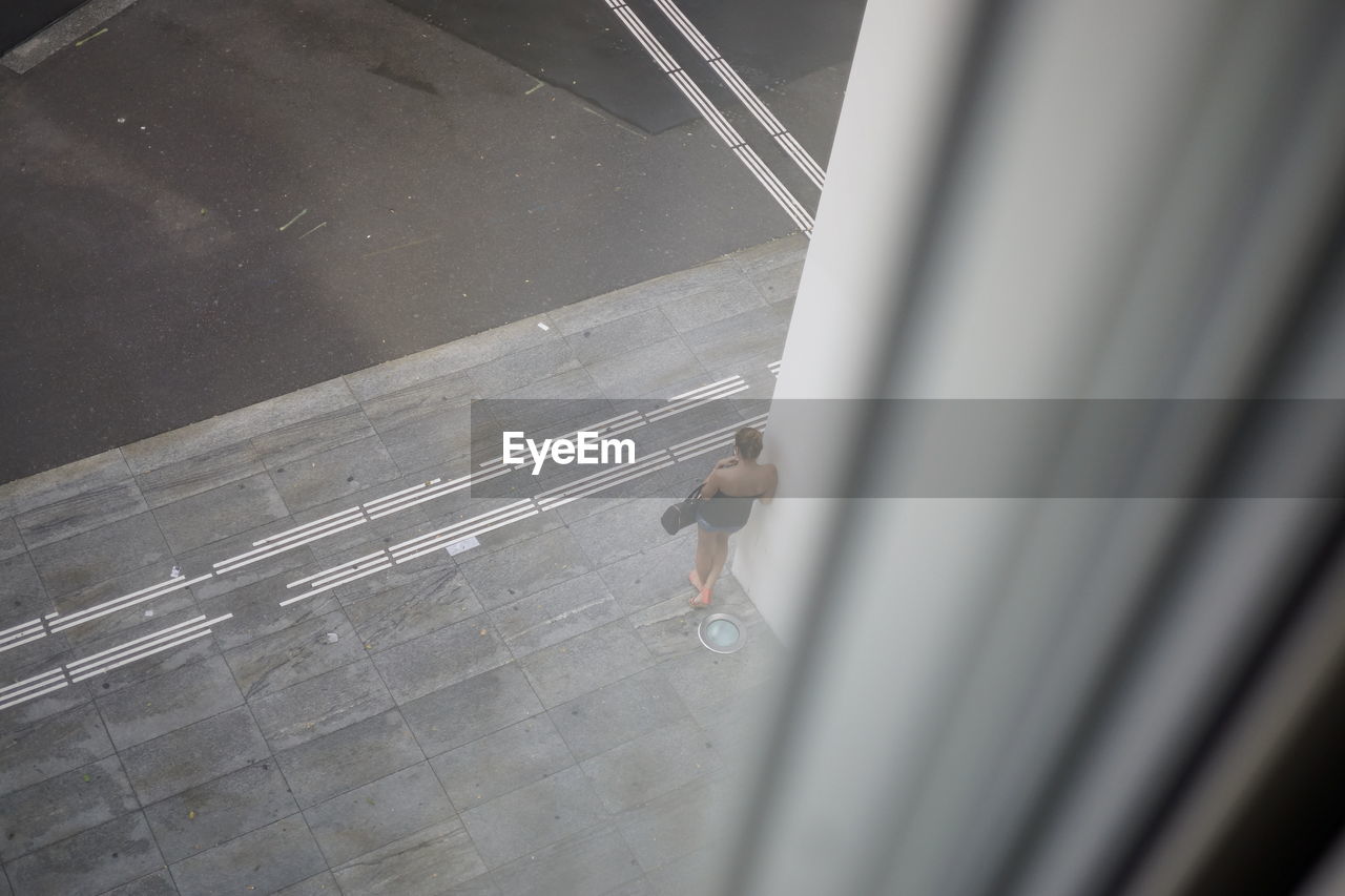 HIGH ANGLE VIEW OF MAN ON STREET AT AIRPORT