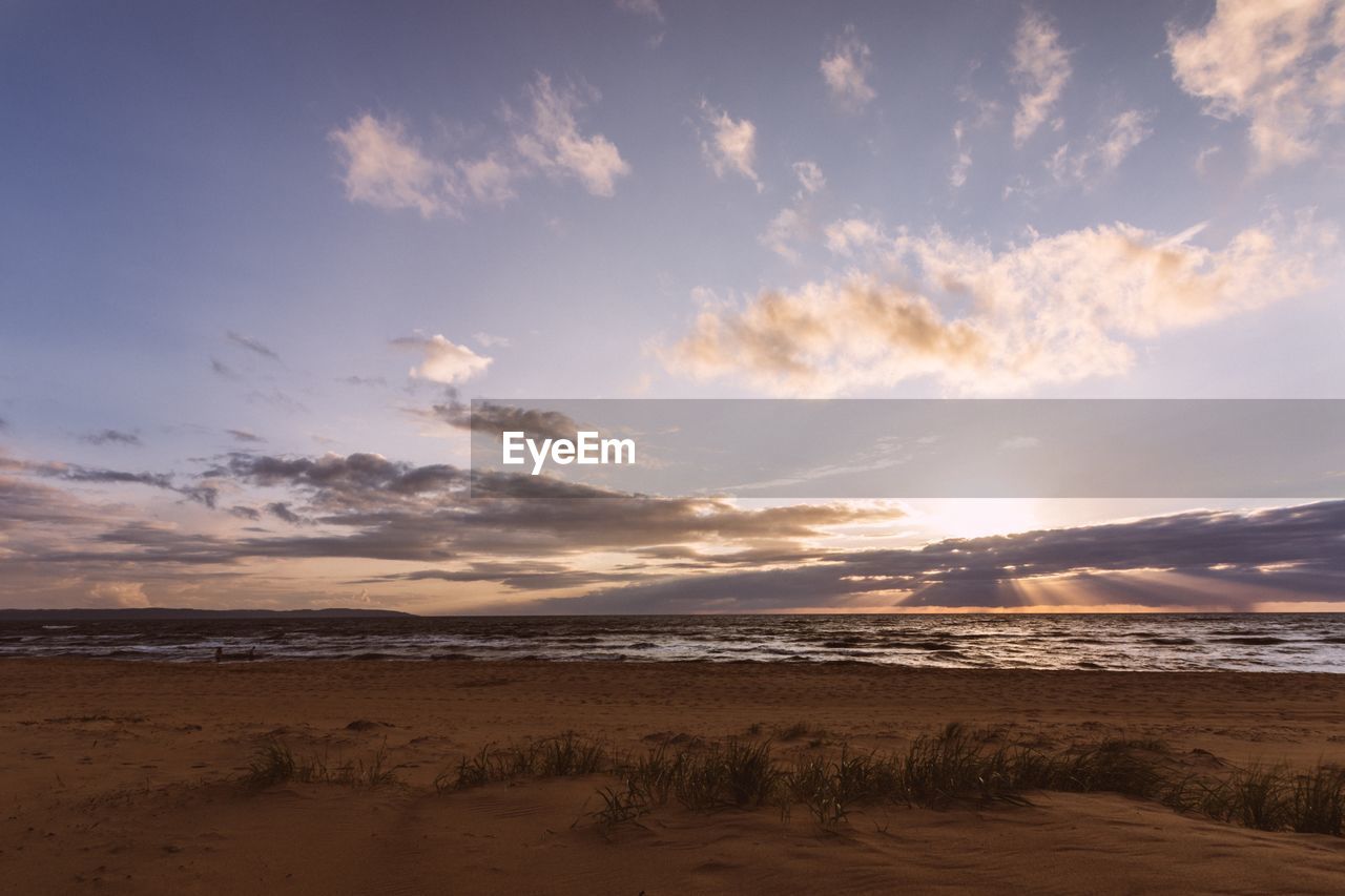 SCENIC VIEW OF BEACH DURING SUNSET