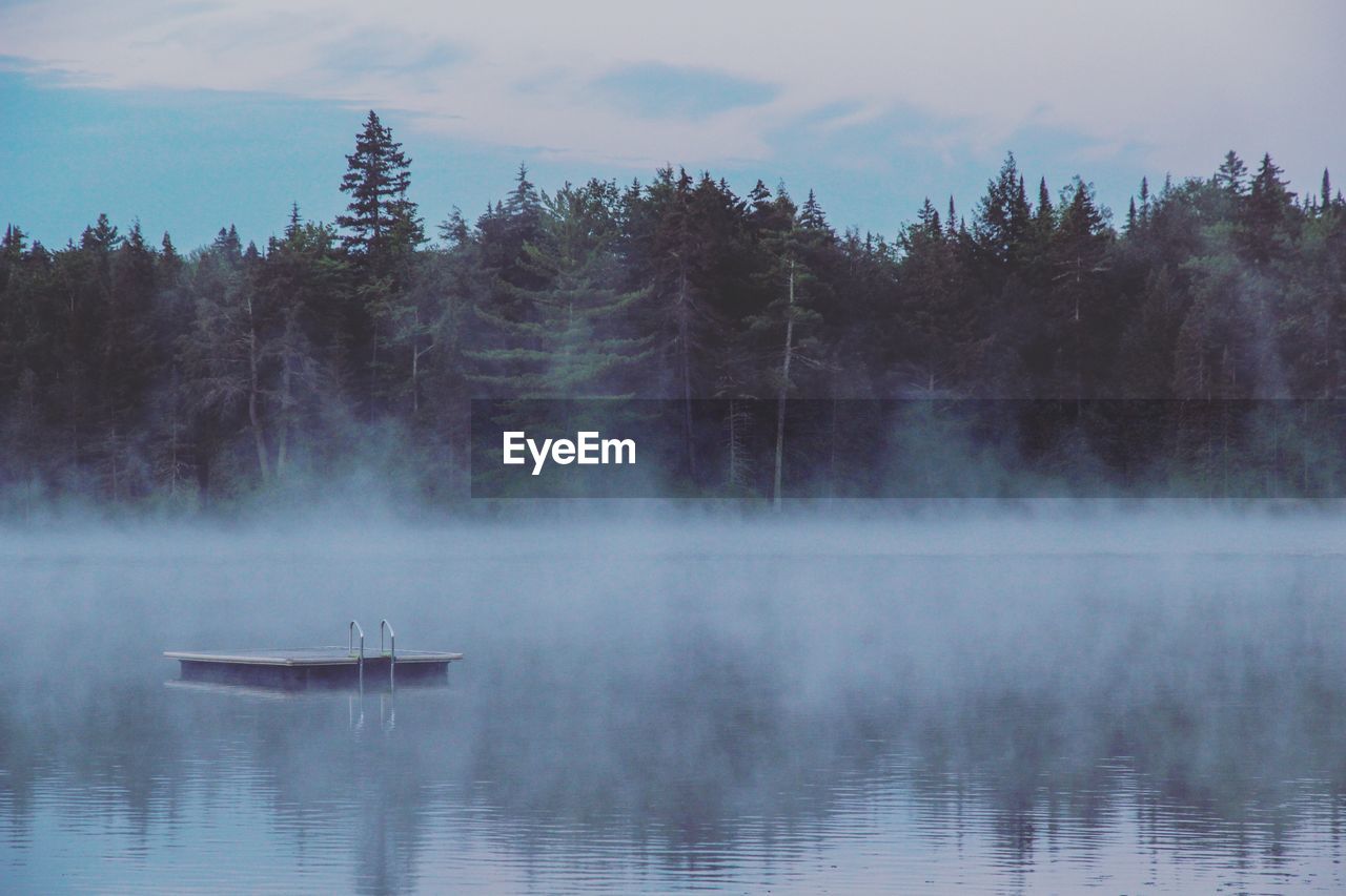 Diving platform over lake during foggy weather