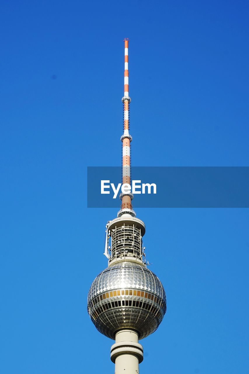 LOW ANGLE VIEW OF TOWER AGAINST BLUE SKY