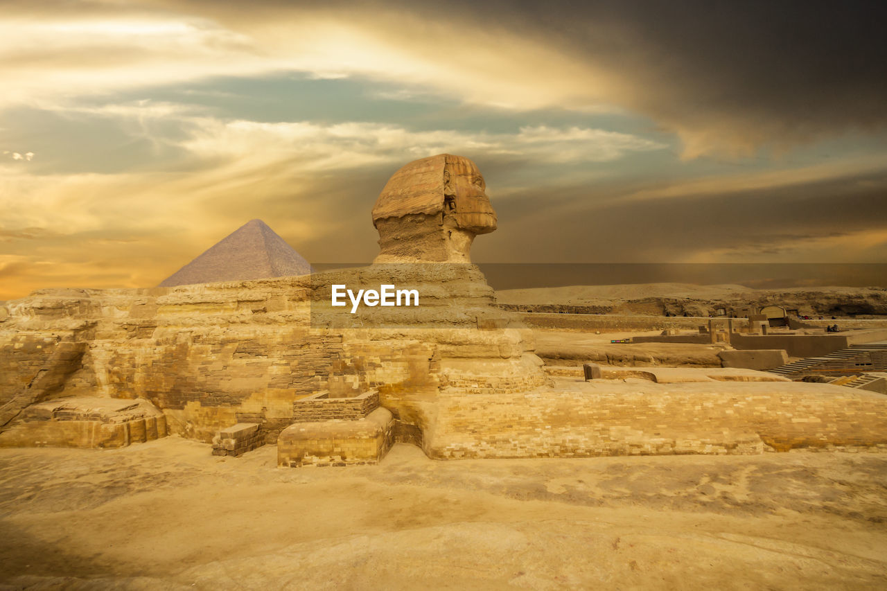 The great sphinx of giza against cloudy sunset sky