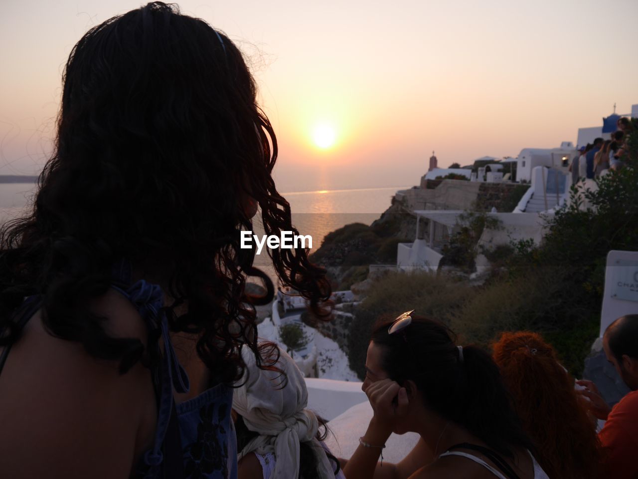 REAR VIEW OF GIRL LOOKING AT SEA