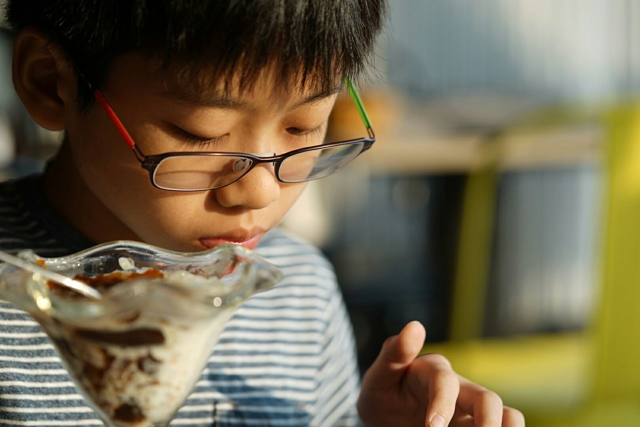 Boy with ice cream in restaurant