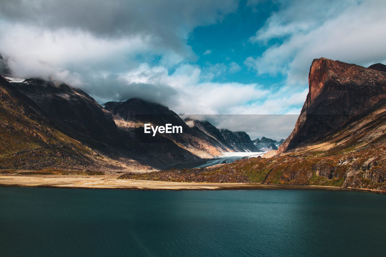 Scenic view of lake and mountains against sky