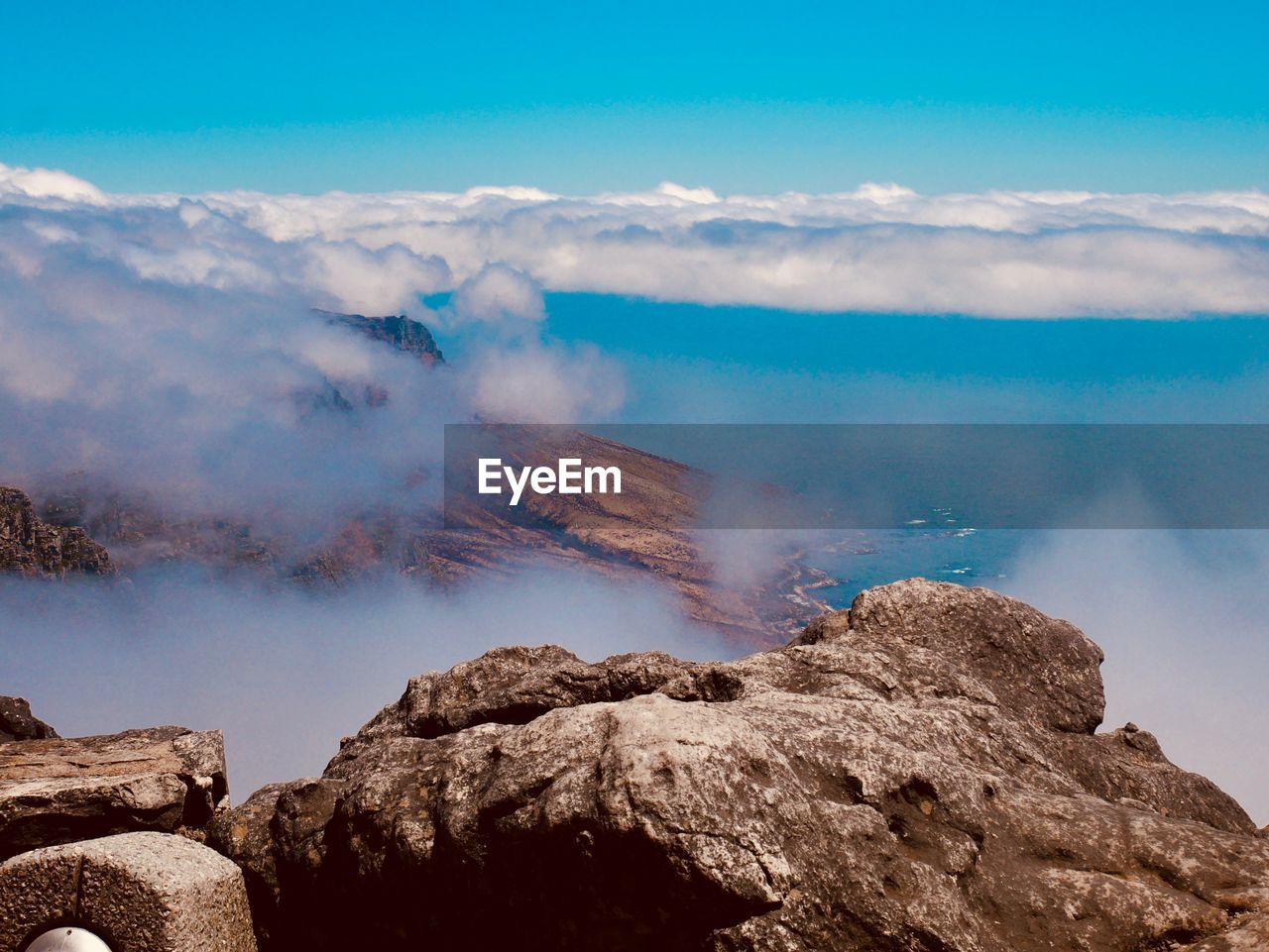 Scenic view of mountains against cloudy sky