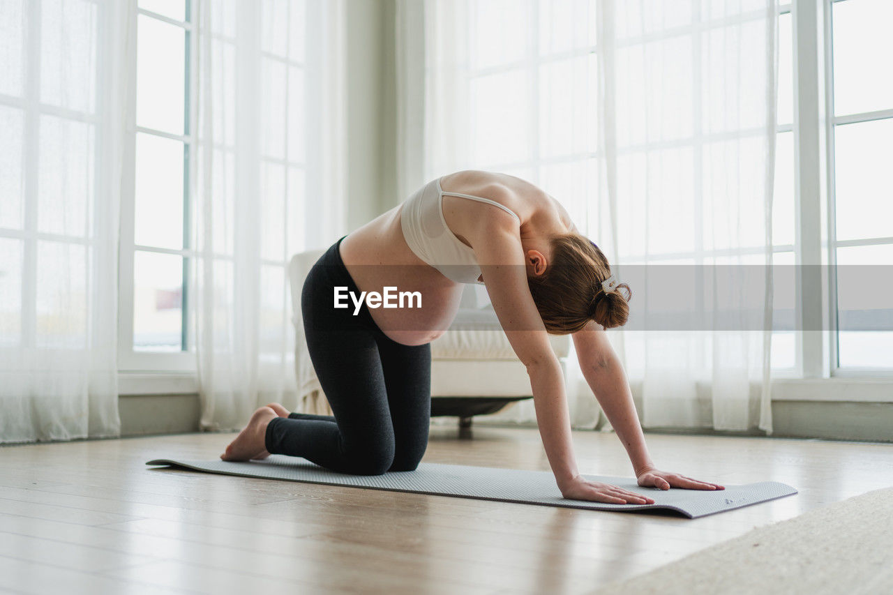 side view of woman exercising in gym