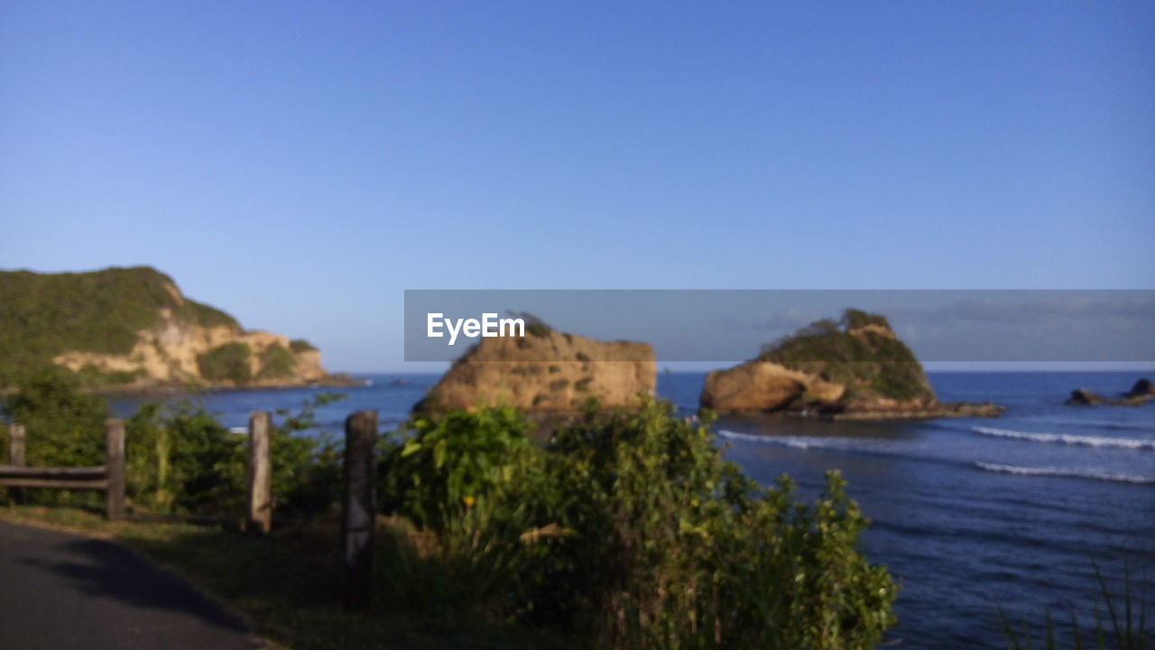 SCENIC VIEW OF SEA WITH ROCKS IN BACKGROUND