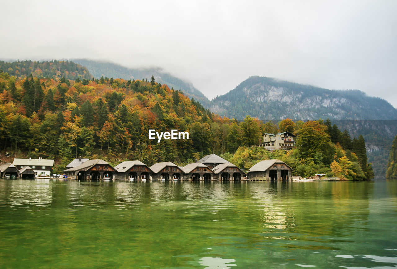 SCENIC VIEW OF LAKE AND BUILDINGS AGAINST SKY